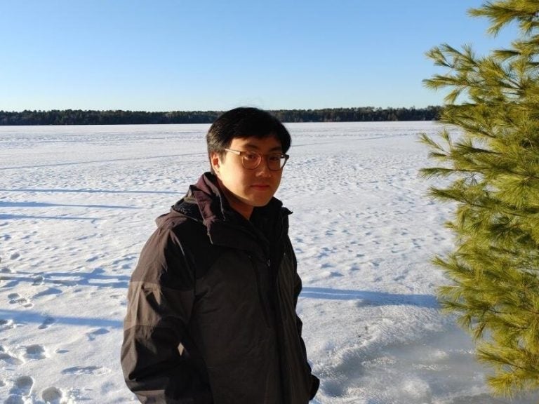 Bao Ha stands outside in the snow