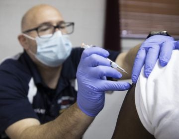 A patient at the Vaccination clinic in McKeesport at the Bethlehem Baptist Church receives the COVID-19 vaccine