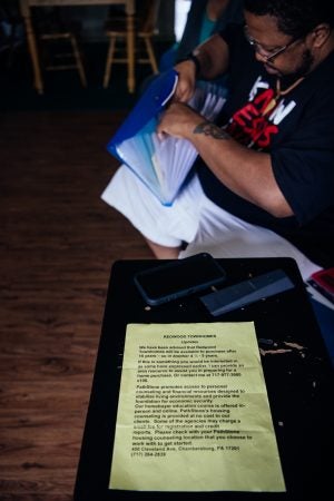 Jonathan Pretlow sifts through paperwork inside his home.