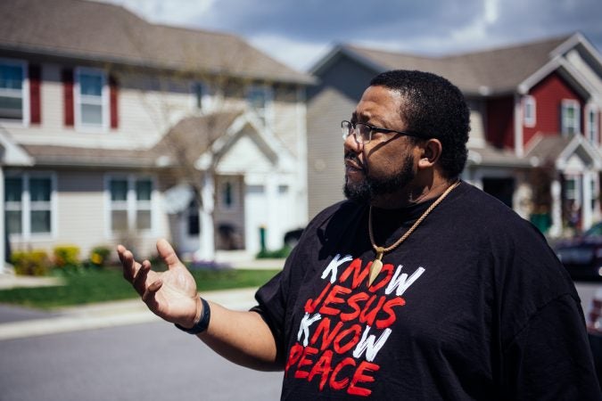 Jonathan Pretlow poses outside townhomes in the neighborhood.