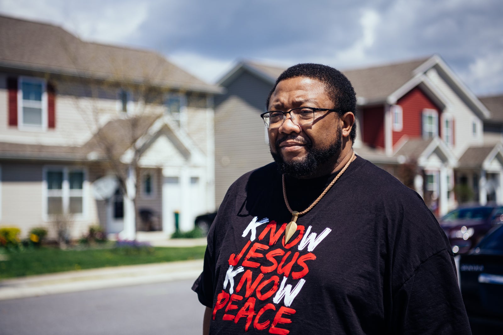 Jonathan Pretlow poses outside townhomes in the neighborhood.