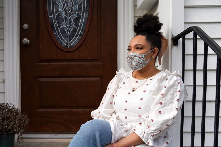 Emily Knowles sits outside her apartment in Watertown, Mass. Knowles has some college credits but no degree and works as a quality assurance analyst at Ovia Health, a Boston-based digital company that serves people who are starting families. 