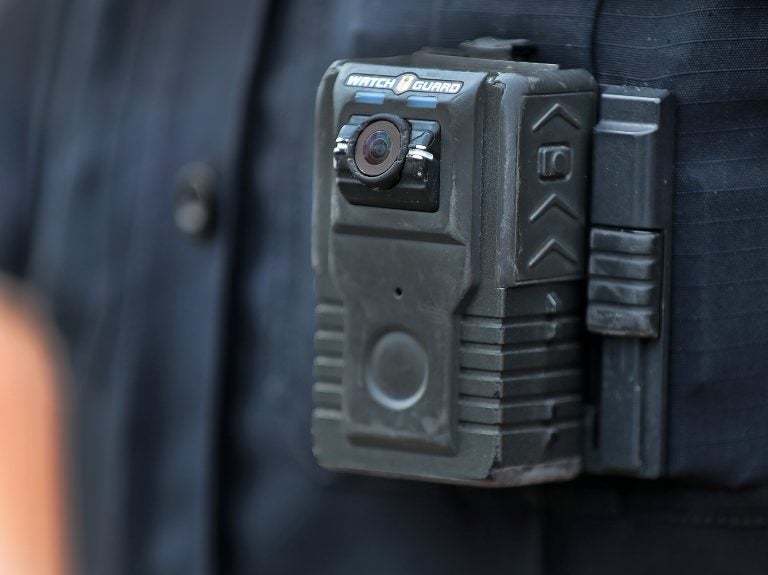 Police officer David Moore is pictured wearing a body camera in Ipswich, Mass., on Dec. 1, 2020. The city was among 25 statewide awarded grants to purchase body-worn cameras for videotaping interactions with the public. A new study says the benefits to society and police departments outweigh the costs of the cameras. (Boston Globe/Boston Globe via Getty Images)