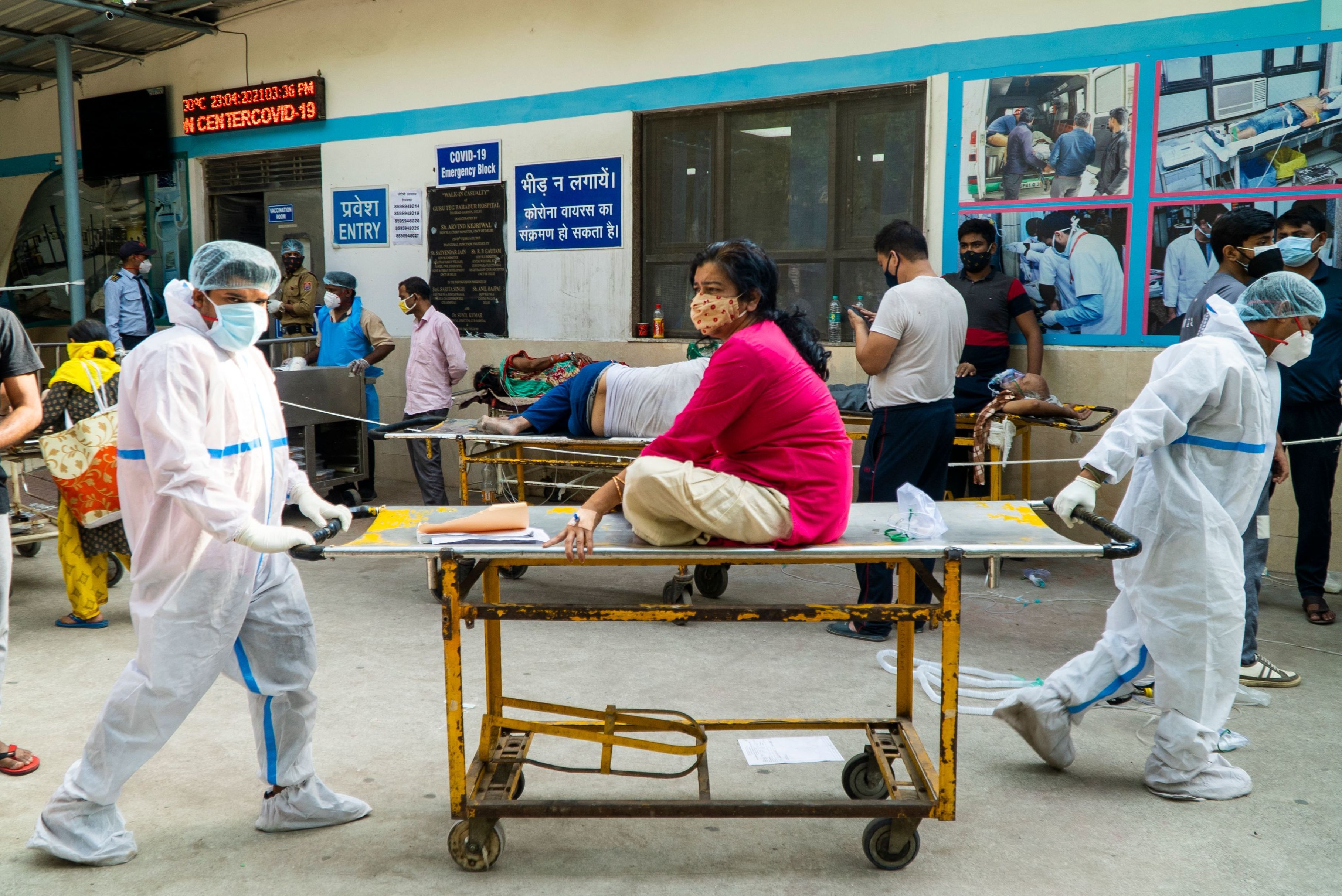 Health workers transport a COVID-19 patient in a hospital complex