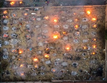 Burning pyres of victims who lost their lives due to the coronavirus are seen at a cremation ground in New Delhi