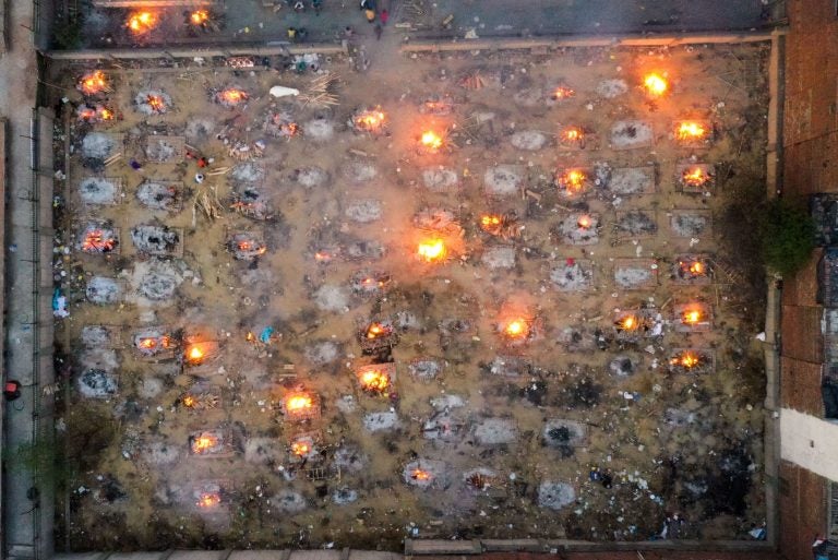 Burning pyres of victims who lost their lives due to the coronavirus are seen at a cremation ground in New Delhi