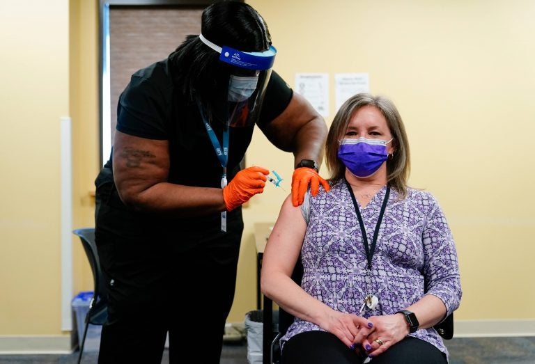 Nurse Monique Bourgeois, left, administers the Johnson & Johnson COVID-19 vaccine to educator Diane Kay at a vaccination site setup for teachers and school staff at the Berks County Intermediate Unit in Reading, Pa., Monday, March 15, 2021.