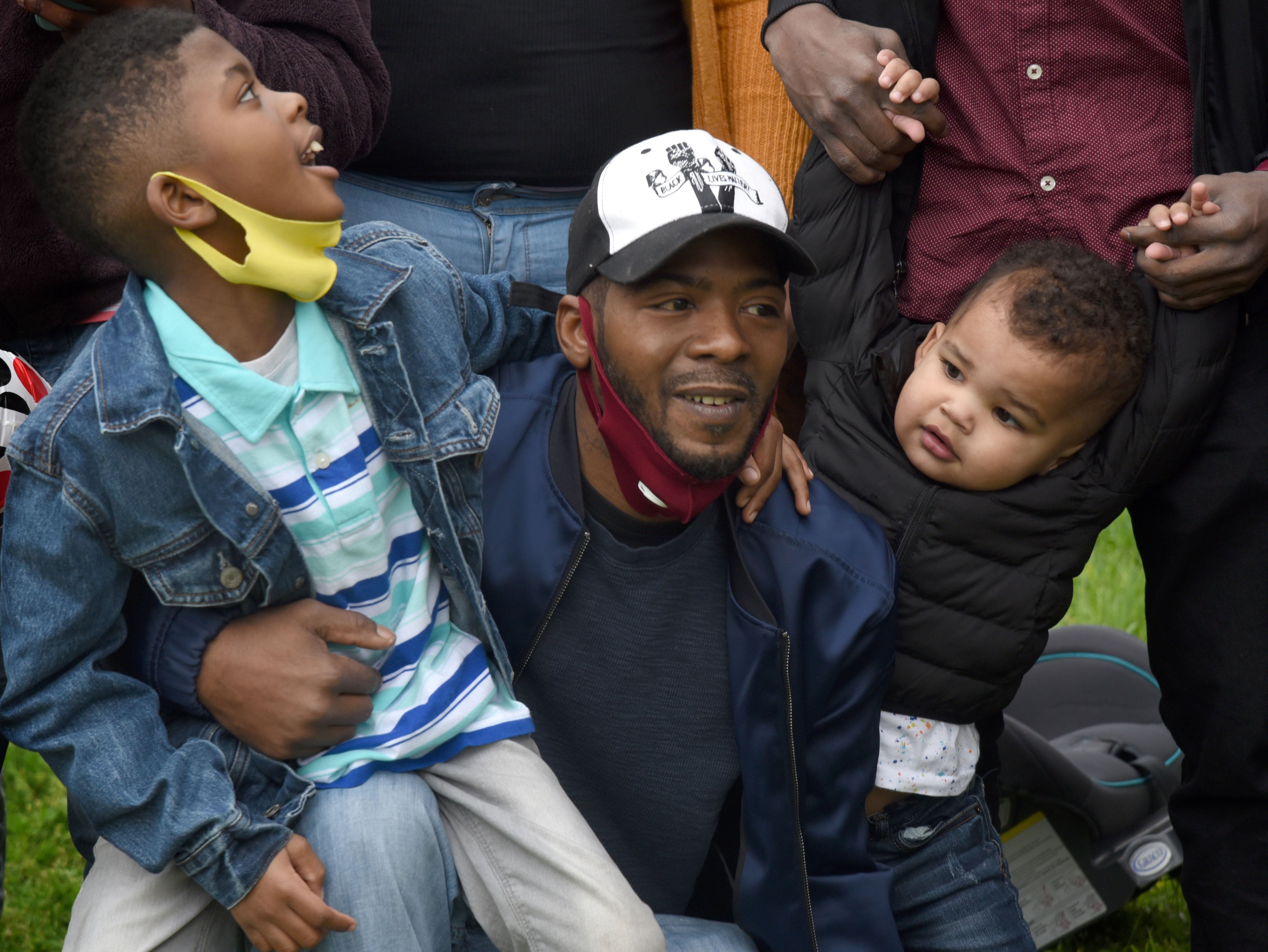 Gary Frazier Jr. (center) sits with his son Denim (left) and grandson Elijah (right)