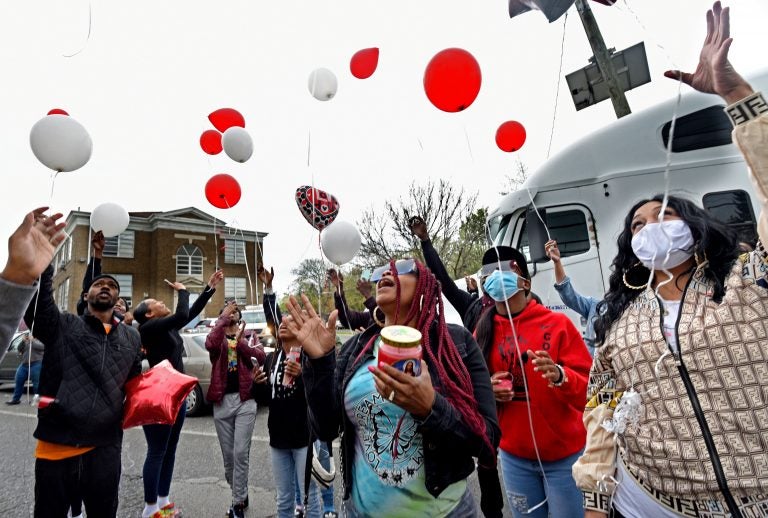 Tomeka Holmes (center) leads family and friends in a balloon release in her son's memory