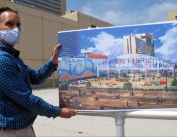 Martin Sizmur, who is in charge of construction for Philadelphia developer Bart Blatstein, shows an illustration of an 8,000-seat domed concert hall to be built next to the Showboat casino, Wednesday, April 21, 2021, in Atlantic City, N.J.