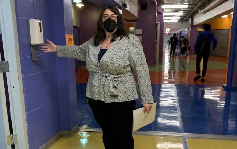 Margaux Munnelly, principal Mastery Charter School-Pickett Campus in Germantown, uses the hand sanitizer station in the hallway. (Dale Mezzacappa/Chalkbeat Philadelphia)