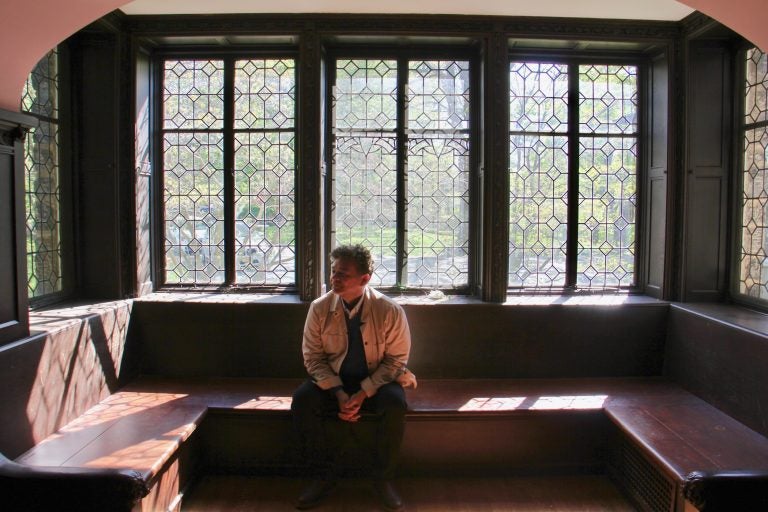 William Valerio, director of the Woodmere Art Museum sits in the Rose Room at St. Michael Hall, envisioning the room as a performance venue. (Emma Lee/WHYY)