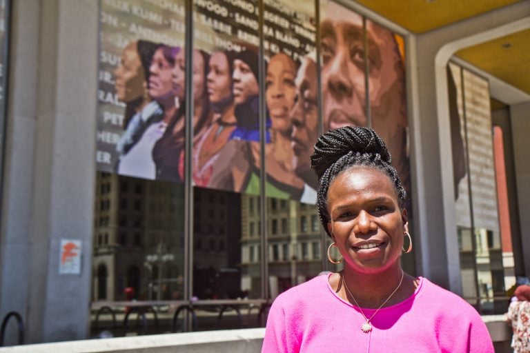 Dr. Ala Stanford, founder of the Black Doctors Consortium, in front of the Crown mural by artist Russell Craig that pays homage to her and other Black women. (Kimberly Paynter/WHYY)