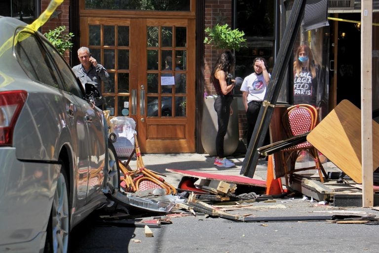 A car crashed into an outdoor dining structure on 4th Street in Northern Liberties, injuring several patrons at Cafe La Maude. (Emma Lee/WHYY)