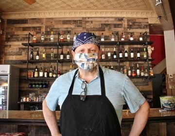 Mike Scotto wears a mask inside Jester's Cafe