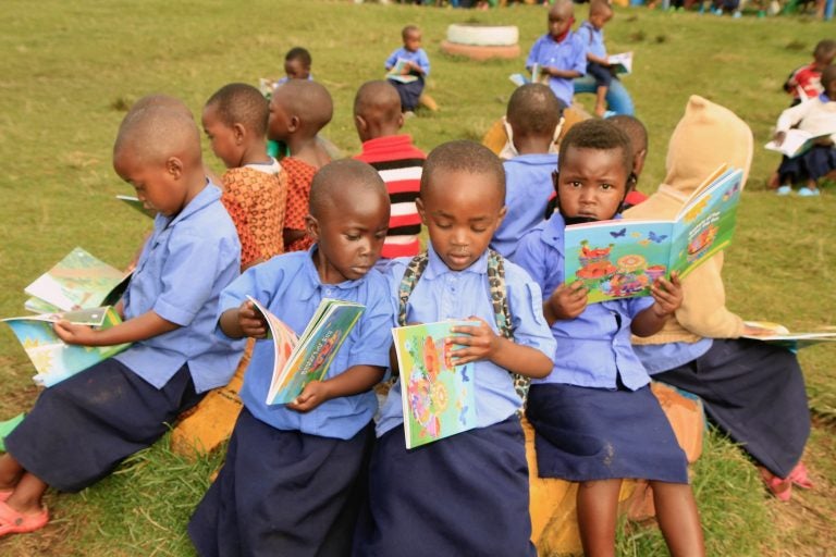 Preschoolers in Rwanda look at the books created for them by String Theory School students in Philadelphia. (Provided by String Theory Schools)