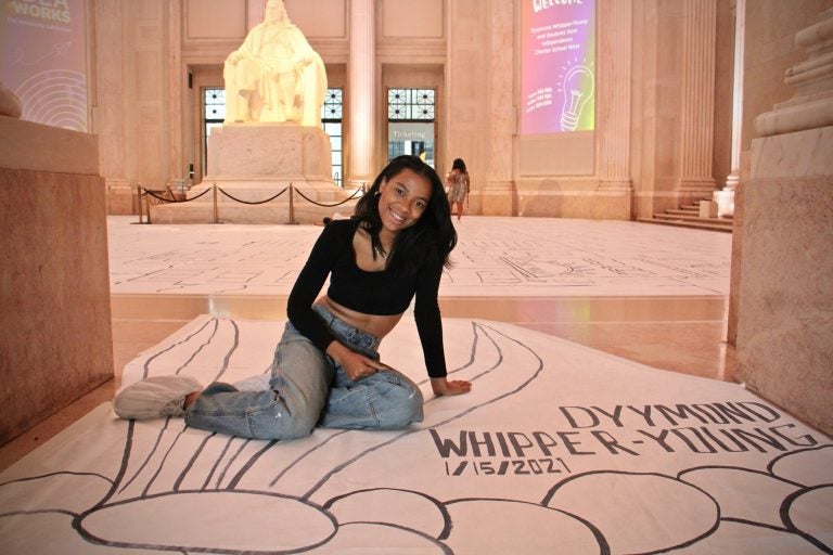 Dyymond Whipper-Young, an art teacher at Independence Charter School created a world-record-breaking drawing for the Franklin Institute's Creativitiy Exhibition. (Emma Lee/WHYY)