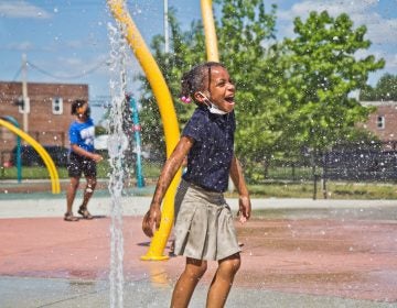 A child plays at a Philly sprayground