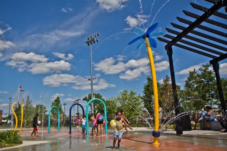 Elated children at Finley Recreation Center in Philadelphia run through the sprayground on the first day of operation, May 27, 2021. (Kimberly Paynter/WHYY)