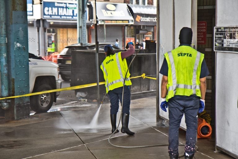 SEPTA workers power wash Allegheny Station on Kensington Avenue. (Kimberly Paynter/WHYY)