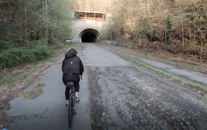 A participant rides their bike through an abandoned Pennsylvania Turnpike tunnel.