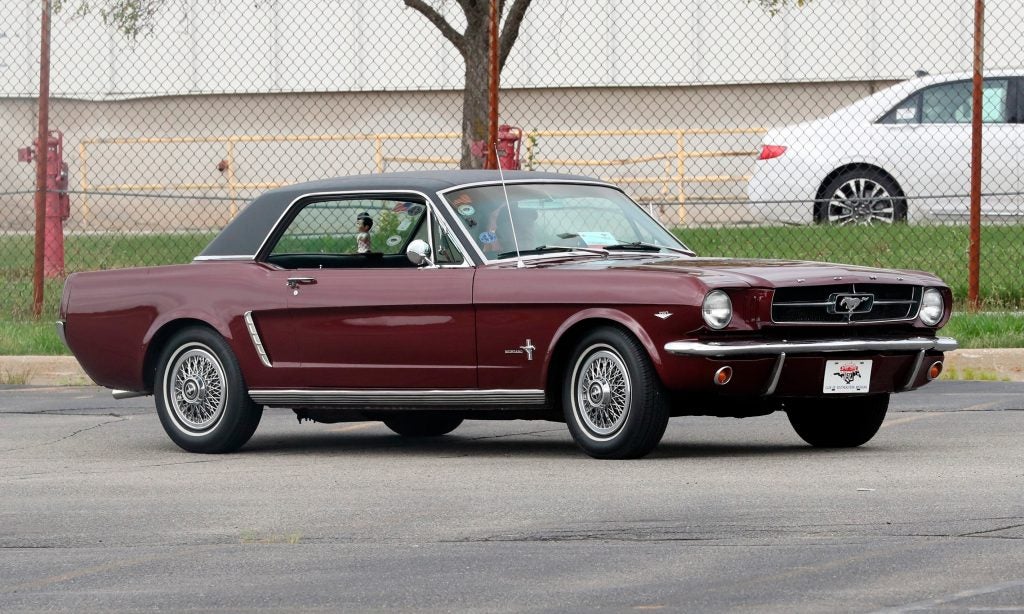 A 1964 Ford Mustang is driven outside the the Flat Rock Assembly plant, Wednesday, Aug. 8, 2018 in Flat Rock, Mich. (AP Photo/Carlos Osorio)