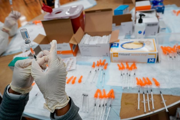 A health worker fills up a syringe with the Johnson & Johnson vaccine