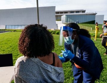 In this May 6, 2021, file photo, Kendria Brown, a nurse with DC health, vaccinates a woman with the Johnson & Johnson COVID-19 vaccine at The REACH at the Kennedy Center in Washington. (AP Photo/Jacquelyn Martin, File)