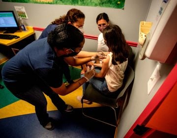 Middle school student Elise Robinson receives her first coronavirus vaccination on Wednesday, May 12, 2021, in Decatur, Ga. (AP Photo/Ron Harris)