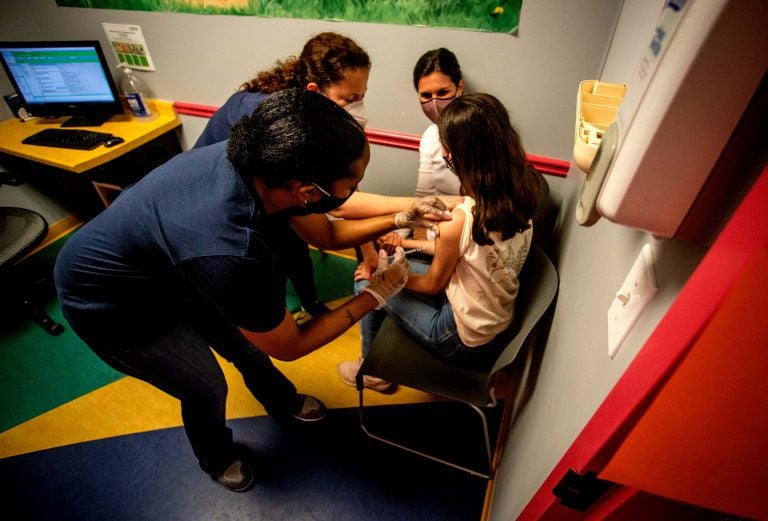 Middle school student Elise Robinson receives her first coronavirus vaccination on Wednesday, May 12, 2021, in Decatur, Ga. (AP Photo/Ron Harris)