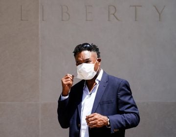 Former NFL player Ken Jenkins exits the building after delivering tens of thousands of petitions demanding equal treatment for everyone involved in the settlement of concussion claims against the NFL, to the federal courthouse in Philadelphia, Friday, May 14, 2021. (AP Photo/Matt Rourke)