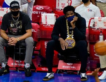 Philadelphia 76ers' Joel Embiid, right, and Ben Simmons watch from the bench during an NBA basketball game against the Orlando Magic, Sunday, May 16, 2021, in Philadelphia. (AP Photo/Matt Slocum)