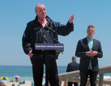 New Jersey Gov. Phil Murphy, left, speaks at a news conference at Island Beach State Park in New Jersey on Wednesday, May 19, 2021, where he announced that the state will give free season-long admission to the park and other state parks to any New Jersey resident who has gotten at least one dose of COVID-19 vaccine by July 4. At right is Shawn LaTourette, the acting environmental protection commissioner. (AP Photo/Wayne Parry)