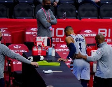 Washington Wizards' Russell Westbrook (4) is helped to the locker room after an injury during the second half of Game 2 in a first-round NBA basketball playoff series against the Philadelphia 76ers, Wednesday, May 26, 2021, in Philadelphia. (AP Photo/Matt Slocum)