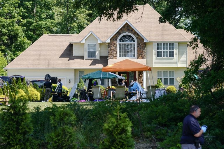 Investigators work the scene of a mass shooting at a Fairfield Township home