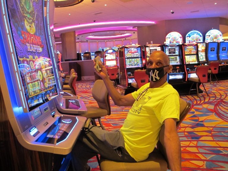 Gary Royster of Atlantic City holds up a wad of cash he used to gamble at the Hard Rock casino in Atlantic City