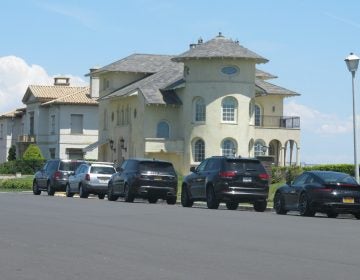 Cars are lined up on an oceanfront street in Deal