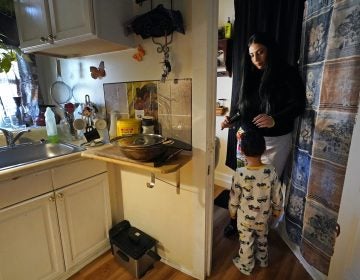 Isabel Miranda brushes the hair of her 4-year-old son, Julian, in their rental apartment