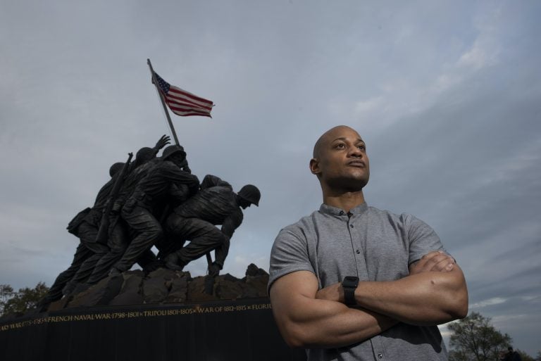 Reserve Marine Maj. Tyrone Collier stands with his arms crossed in front of the U.S. Marine Corps War Memorial