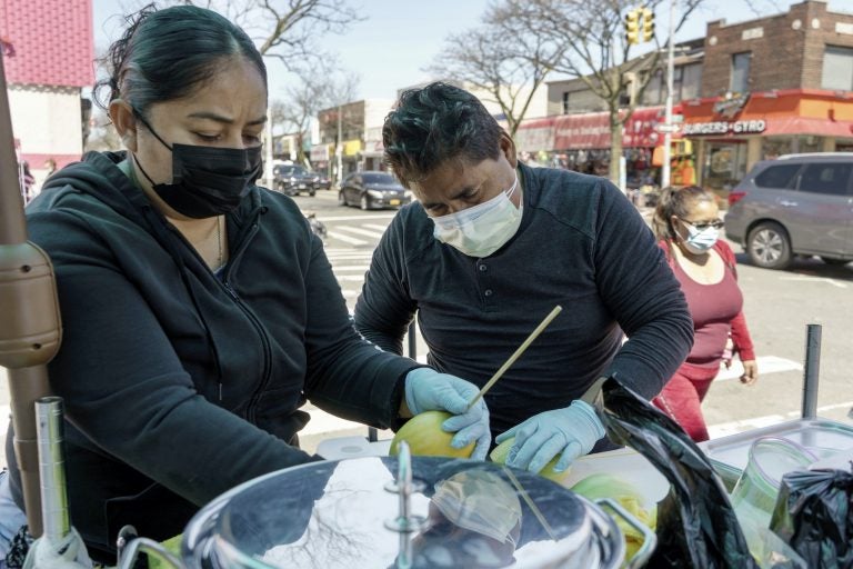 Ruth and Arturo work at their fruit stand