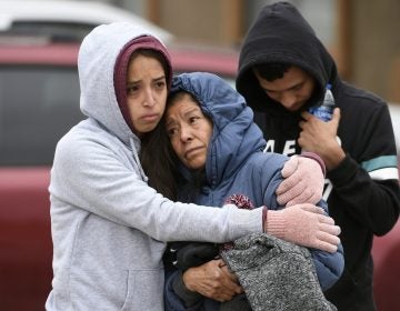 Family members hug each other on the street