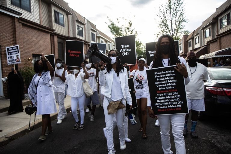 Social justice organizers and surviving members of the MOVE family march down the 6200 block of Osage Avenue on May 13, 2021. (Kimberly Paynter/WHYY)