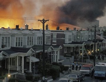FILE - In this May, 1985 file photo, scores of row houses burn in a fire in the west Philadelphia neighborhood. Police dropped a bomb on the militant group MOVE's home on May 13, 1985 in an attempt to arrest members, leading to the burning of scores of homes in the neighborhood. A day after Philadelphia's health commissioner was forced to resign over the cremation of partial remains thought to belong to victims of a 1985 bombing of the headquarters of a Black organization, the city now says those victims' remains were never destroyed. City officials told the victims' family Friday, May 14, 2021 that a subordinate had disobeyed Health Commissioner Thomas Farley’s 2017 order to dispose of the remains. (AP Photo/File)