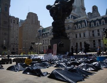 Rosalind Pichardo stands amid body bags during a rally