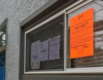 A 2019 property violation notice on display in a Fishtown home's window