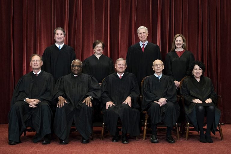 FILE - In this April 23, 2021, file photo members of the Supreme Court pose for a group photo at the Supreme Court in Washington. Seated from left are Associate Justice Samuel Alito, Associate Justice Clarence Thomas, Chief Justice John Roberts, Associate Justice Stephen Breyer and Associate Justice Sonia Sotomayor, Standing from left are Associate Justice Brett Kavanaugh, Associate Justice Elena Kagan, Associate Justice Neil Gorsuch and Associate Justice Amy Coney Barrett. Before the Supreme Court this is week is an argument over whether public schools can discipline students over something they say off-campus. (Erin Schaff/The New York Times via AP, Pool, File)