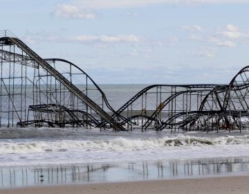 A rollercoaster that once sat on the Funtown Pier in Seaside Heights, N.J., rests in the ocean on Wednesday, Oct. 31, 2012 after the pier was washed away by superstorm Sandy. (Julio Cortez/AP)