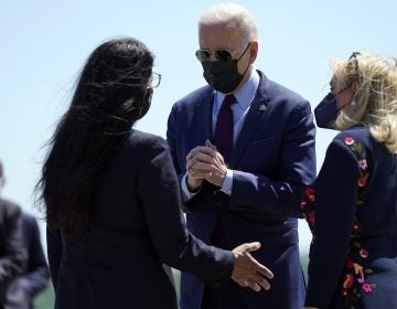 President Biden speaks with Reps. Rashida Tlaib (left) and Debbie Dingell on Tuesday after arriving in Detroit. Tlaib, a progressive Democrat and the first Palestinian American woman in Congress, expressed her opposition toward U.S. policy with Israel to Biden. (Evan Vucci/AP Photo)