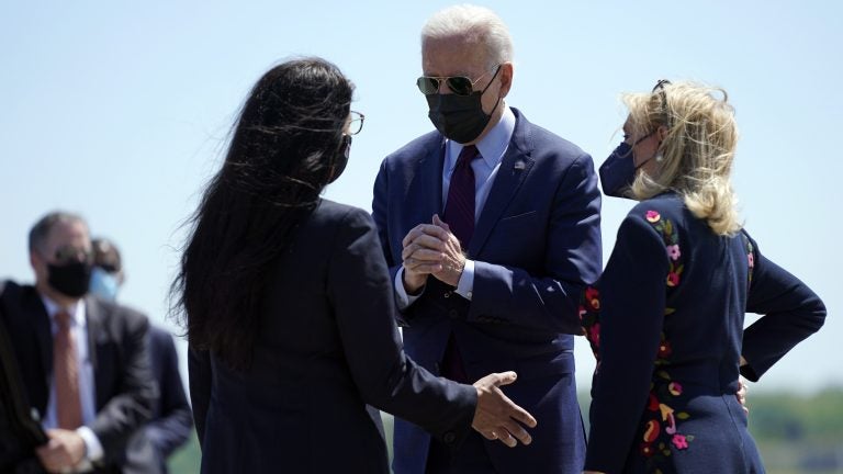 President Biden speaks with Reps. Rashida Tlaib (left) and Debbie Dingell on Tuesday after arriving in Detroit. Tlaib, a progressive Democrat and the first Palestinian American woman in Congress, expressed her opposition toward U.S. policy with Israel to Biden. (Evan Vucci/AP Photo)