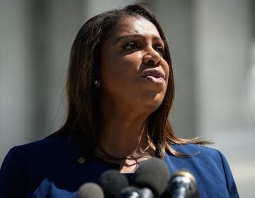 New York Attorney General Letitia James stands in front of a mic